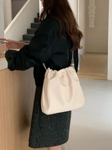 Minimalist pleated cloud shoulder bag for women, versatile PU leather crossbody bucket bag.