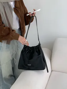 Detailed view of black pleated cloud shoulder bag, minimalist casual commute crossbody design.