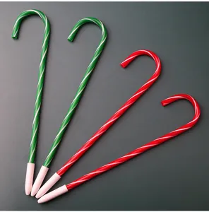 Detailed view of creative Christmas candy cane ballpoint pens in red and green color design.