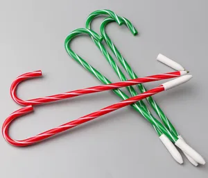 Close-up details of festive Christmas candy cane pens showcasing red and green striped patterns.