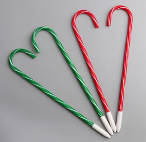 Close-up view of novelty candy cane ballpoint pens, featuring cute red and green holiday design.