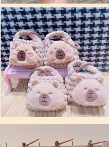 Cute capybara plush coin purse detail shot, soft knitted mini bag and bag charm pendant.