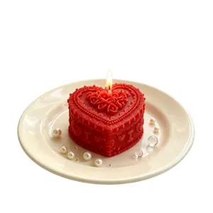 Handmade red heart-shaped scented soy wax candle with rose floral embossed design for romantic gifts.