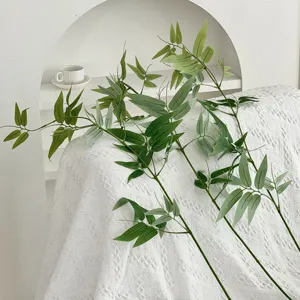 Close-up of artificial green bamboo leaves, Zen indoor plant decor for tea room soft furnishing.