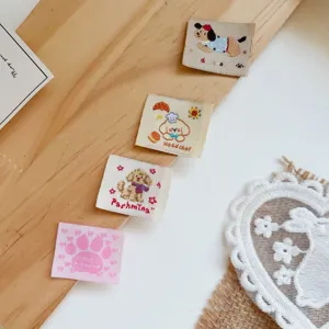 Cute cartoon woven labels, embroidered dog patches, colorful fabric sewing accessories for DIY crafts.