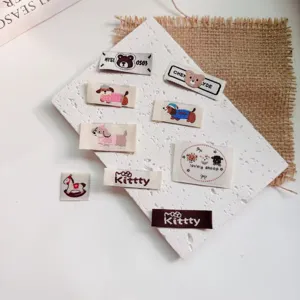 Cute animal embroidery patches detail view, cartoon bear and dog clothing woven labels for DIY.