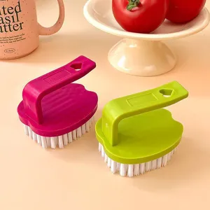 Multifunctional cleaning brush with ergonomic handle for kitchen pot and board cleaning.