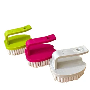 Multi-functional plastic cleaning brush with comfortable handle for kitchen use.