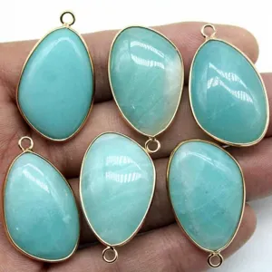 Detail view of teardrop natural stone bezel set gold plated pendant for DIY jewelry making.