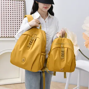 Sac à dos imperméable en nylon pour femme, voyage décontracté grand cartable école en jaune.