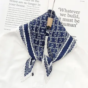 Stylish blue and white pleated geometric print neckerchief, elegant fashion scarf accessory detail.
