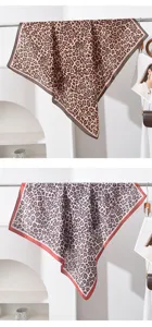 Vue détaillée du foulard carré imprimé léopard, texture de soie élégante, accessoire chic.
