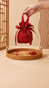 Red fabric wedding candy bag with drawstring design, perfect for gift packaging and celebrations.