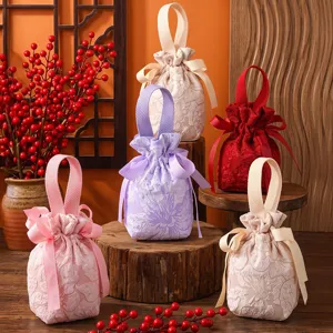 Wedding favor candy gift bags, portable drawstring fabric pouches with elegant lace design.