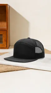 Black 7-panel trucker hat with mesh back and flat brim, perfect for custom logo printing.