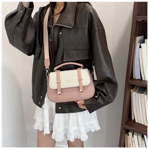 Stylish color-block shoulder handbag for women, retro saddle bag with wide strap and top handle.