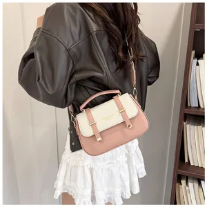 Retro pink and white colorblock saddle bag with double belt design, stylish shoulder handbag for women.