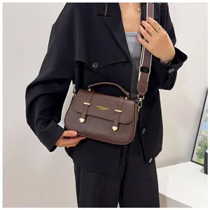 Dark brown leather top-handle crossbody saddle bag with wide strap, retro vintage design detail.