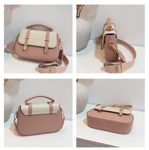 Chic two-tone saddle bag for women, featuring a top handle and adjustable crossbody strap.