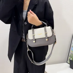 Two-tone leather saddle bag with double strap design, stylish shoulder and crossbody handbag.