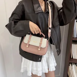 Stylish two-tone saddle bag for women with chic double belt buckle and comfortable shoulder strap.