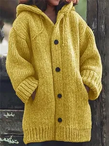 Detailed view of the yellow knitted hooded cardigan featuring chunky knit and front buttons.