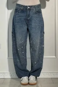 Detailed view of women's high-waisted denim jeans featuring sparkling rhinestone embellishments.