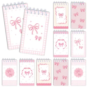 Close up details of cute pink bow spiral memo pads, aesthetic stationery design for daily notes.
