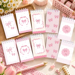 Pink bow spiral notebook detail shot, aesthetic student stationery pocket notepad.