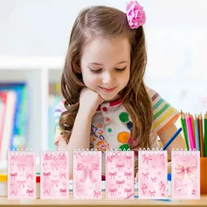 Cute pink bow spiral notebook detail showing sweet student stationery design for daily journaling.