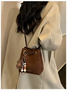 Retro brown suede bucket bag for women, versatile single shoulder and crossbody commuter bag.