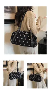 Detail view of stylish black polka dot shoulder bag, trendy casual underarm bag design.