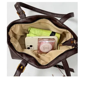 Top-down interior view of the large capacity dark brown PU leather tote bag with storage.