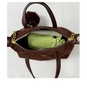 Detail view of brown suede women handbag interior capacity showing daily essentials storage.