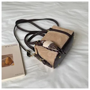 Detailed view of retro brown suede leather handbag showing exquisite texture and stitching.