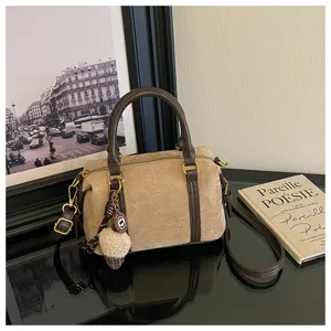 Vintage suede handbag for women, casual shoulder cross body bag with retro design and top handle.