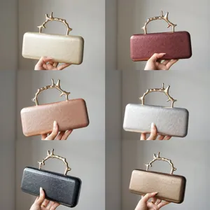 Elegant metal branch handle evening clutch bag with luxury leather texture, multi-color.