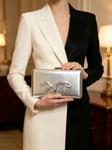 Silver metallic clutch bag detail featuring abstract liquid metal design and sparkly rhinestones.