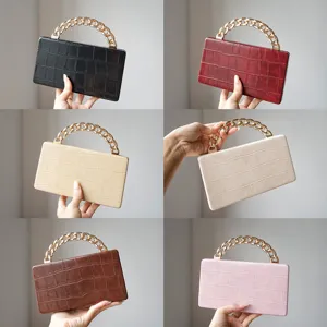 Elegant crocodile pattern clutch bag with metal chain handle for stylish daily commuting use.