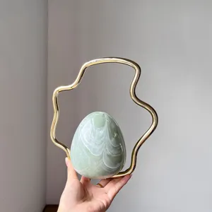 Stunning green gradient egg evening bag featuring unique metallic gold handle detail.