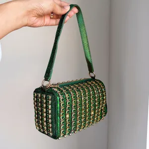 Green rhinestone studded handbag detail showing the sparkling crystals and metallic hardware.