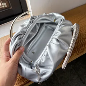 Silver pleated evening clutch bag with metallic handle and soft faux leather for women chic party.
