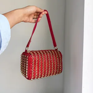 Detail view of a luxurious red crystal rhinestone shoulder bag, sparkling box handbag for women.