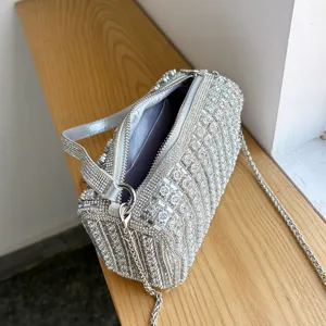 Sparkling rhinestone cylinder shoulder bag with chain strap, luxury evening crossbody bag detail.
