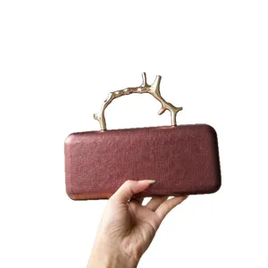 Luxury metal branch handle evening clutch bag for women, elegant leather texture purse main view.