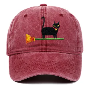 Close-up detail of the retro washed baseball cap featuring a cute black cat and broom embroidery.