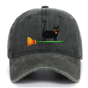 Close-up view of the cute black cat and broom embroidery detail on the vintage cap.