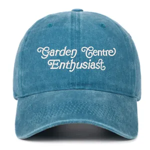 Close-up detail of the embroidered lettering on the front of the vintage washed blue baseball cap.