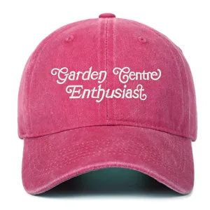 Detailed view of the pink vintage washed baseball cap featuring white embroidered text.