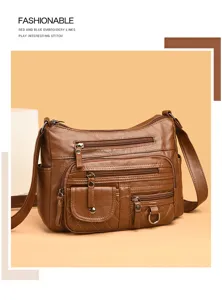 Close-up view of the multi-pocket soft leather shoulder bag showing zipper details and strap.